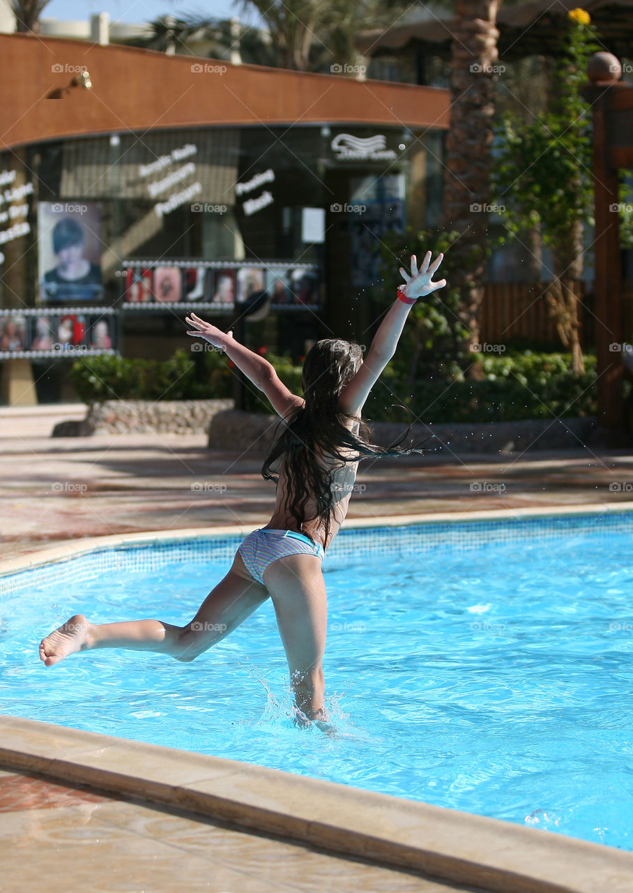 Girl diving into swimming pool 