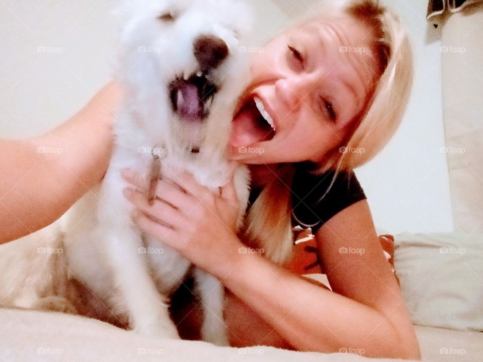 young woman and dog sneezing at the same time