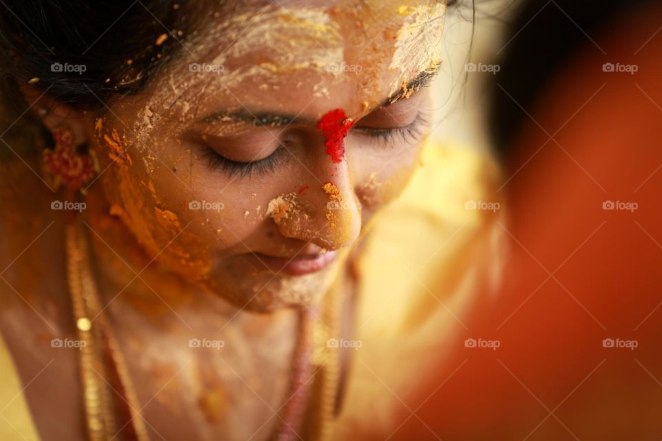 Indian bride with turmeric on her face