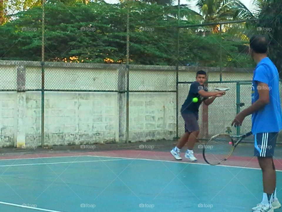 Thai teen boy playing tennis