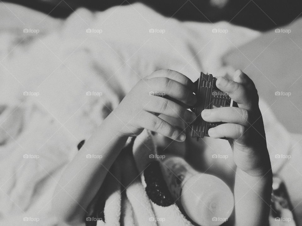 My son playing while drinking the milk bottle