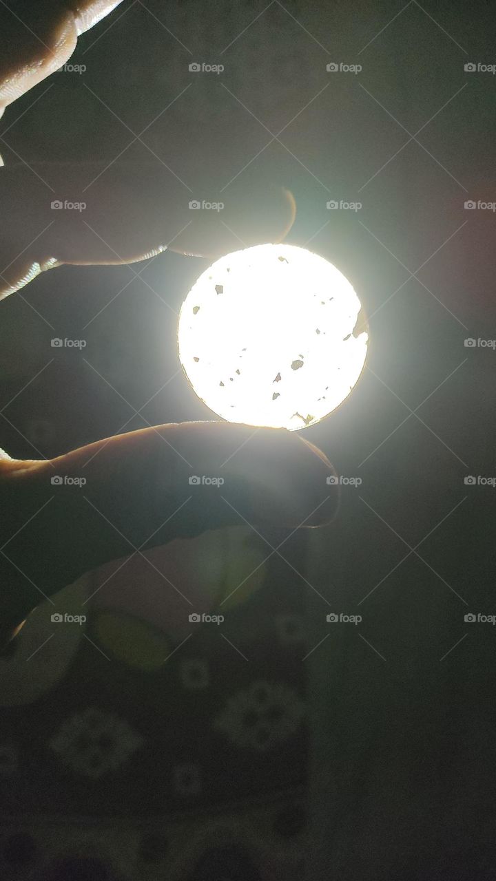 I shone the useless things in the light of the torch.  Looked very beautiful. 
Looks exactly like the moon.