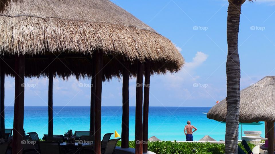 Man contemplating sea on a caribbean luxury beach