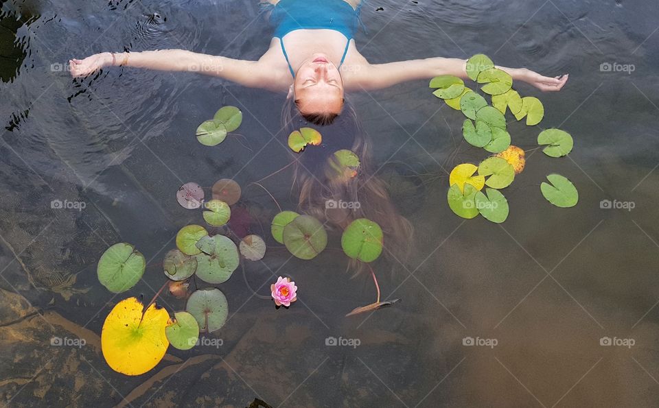 woman in the pond with waterlilies