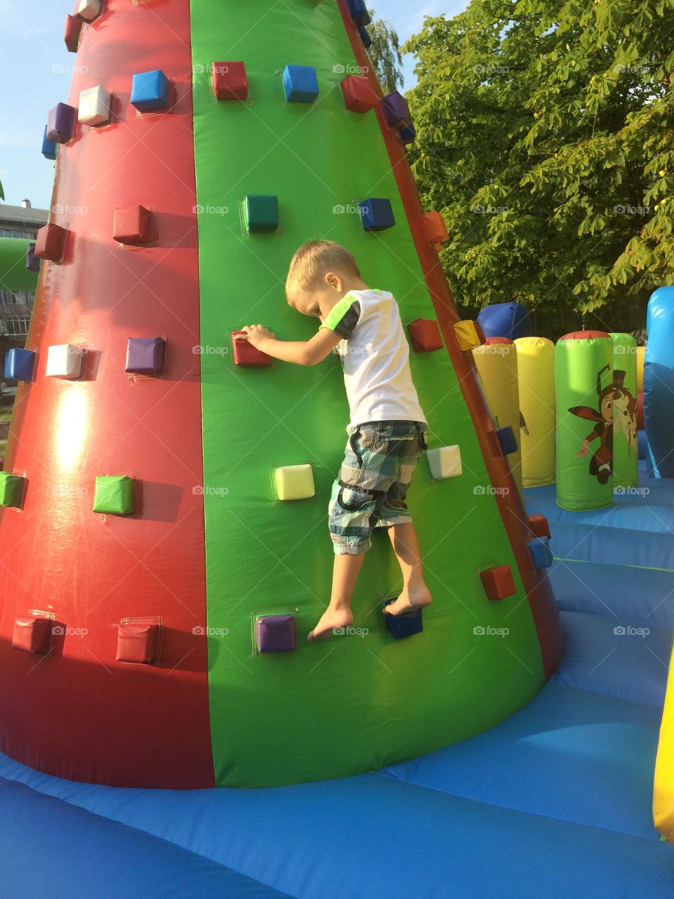 Playground. Boy is climbing