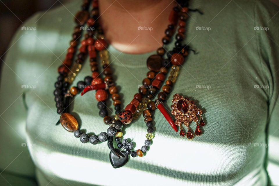 Tiger's eye, volcanic stone necklace and opal brooch