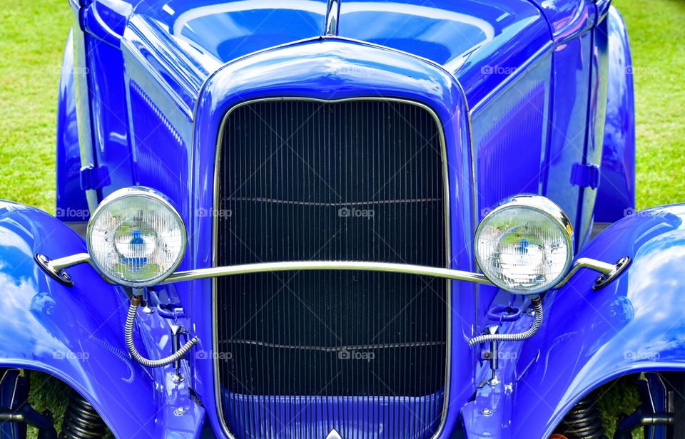 Classic car grill and headlights With a stunning blue paint job