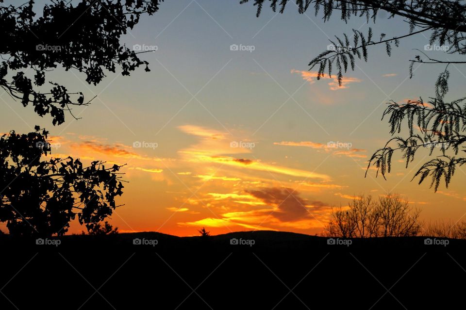 Landscape view with sunset colored clouds