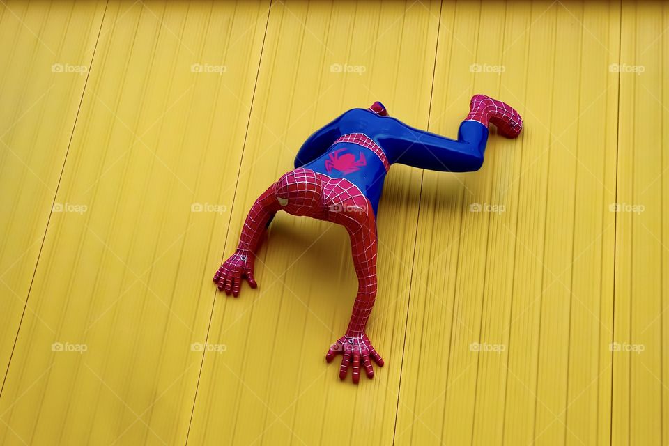 spiderman on yellow wall