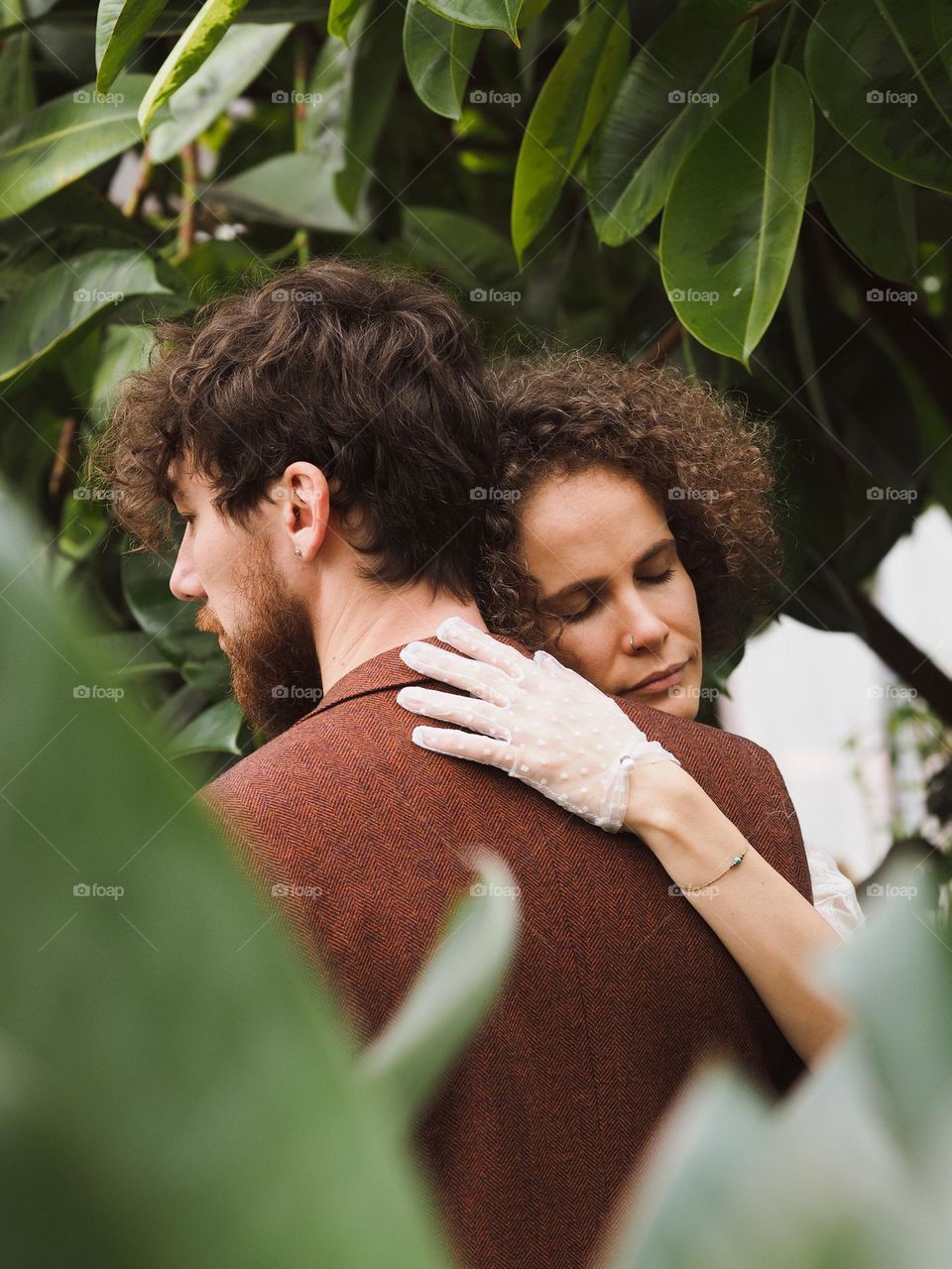 Young beautiful lovers in botanical garden 