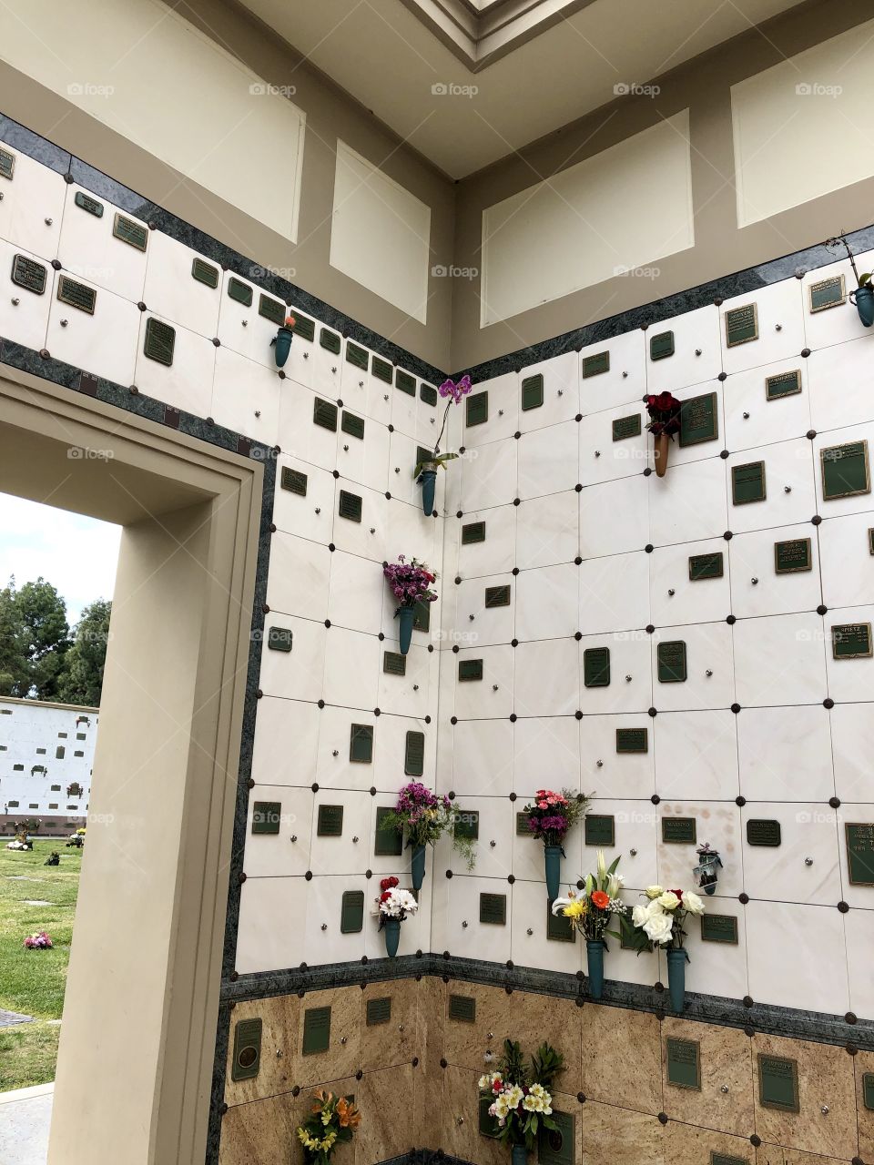 Memorial wall with view to more of cemetery.