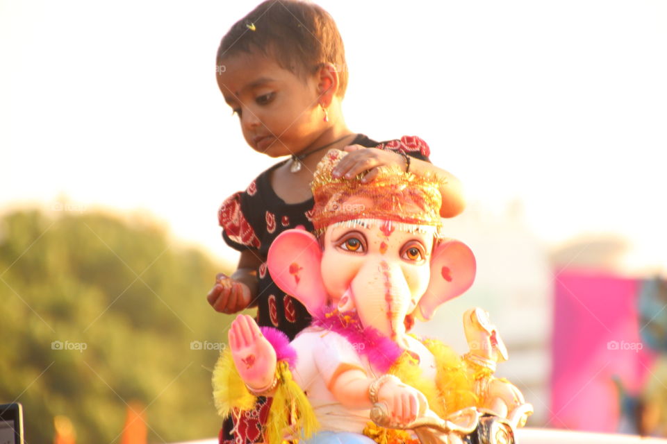 Innocent baby girl with religious god ideal