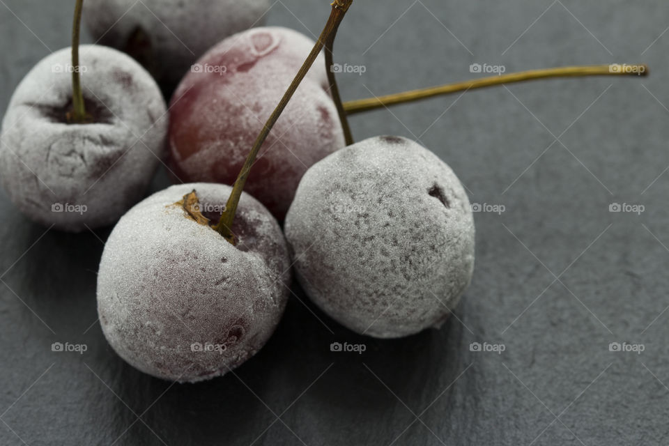 Group Of Frozen Cherries on a dark background Close Up