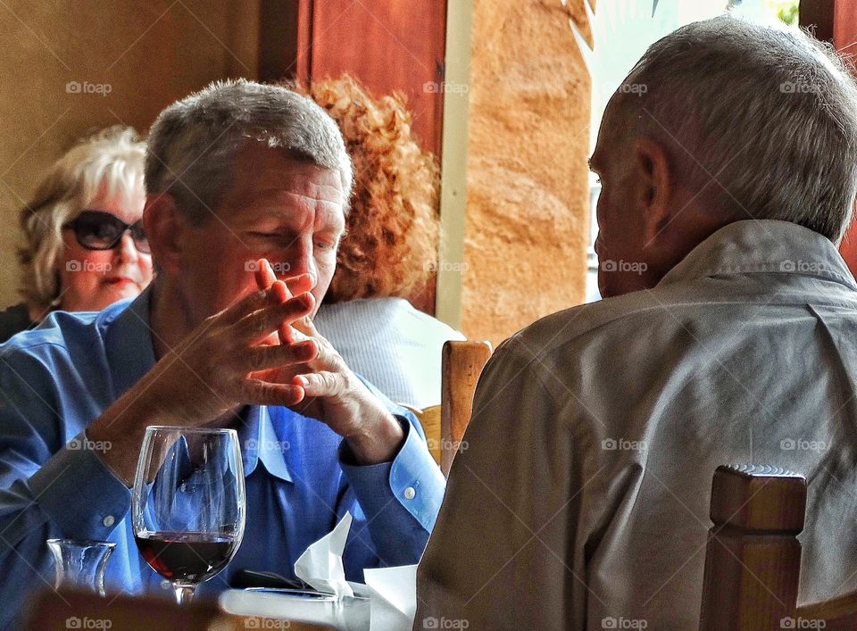 Gay Marriage. Happily Married Older Gay Men Eating Dinner At A Restaurant
