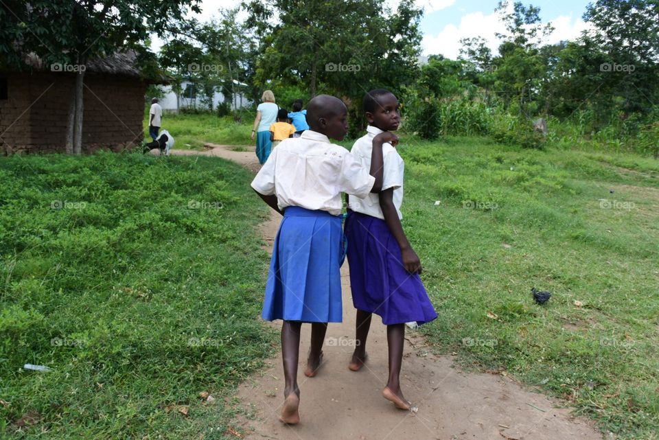 Friends . African school girls walking home 