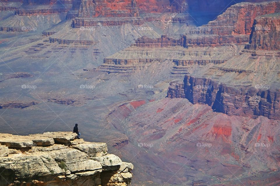 Guy on a cliff at the Grand Canyon