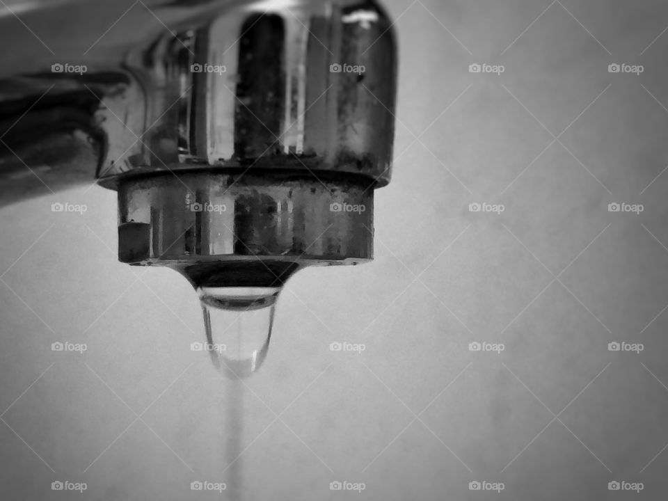 Water Drop... A faucet that is barely closed, dripping, wasting water... But still, a fascinating sign to observe.