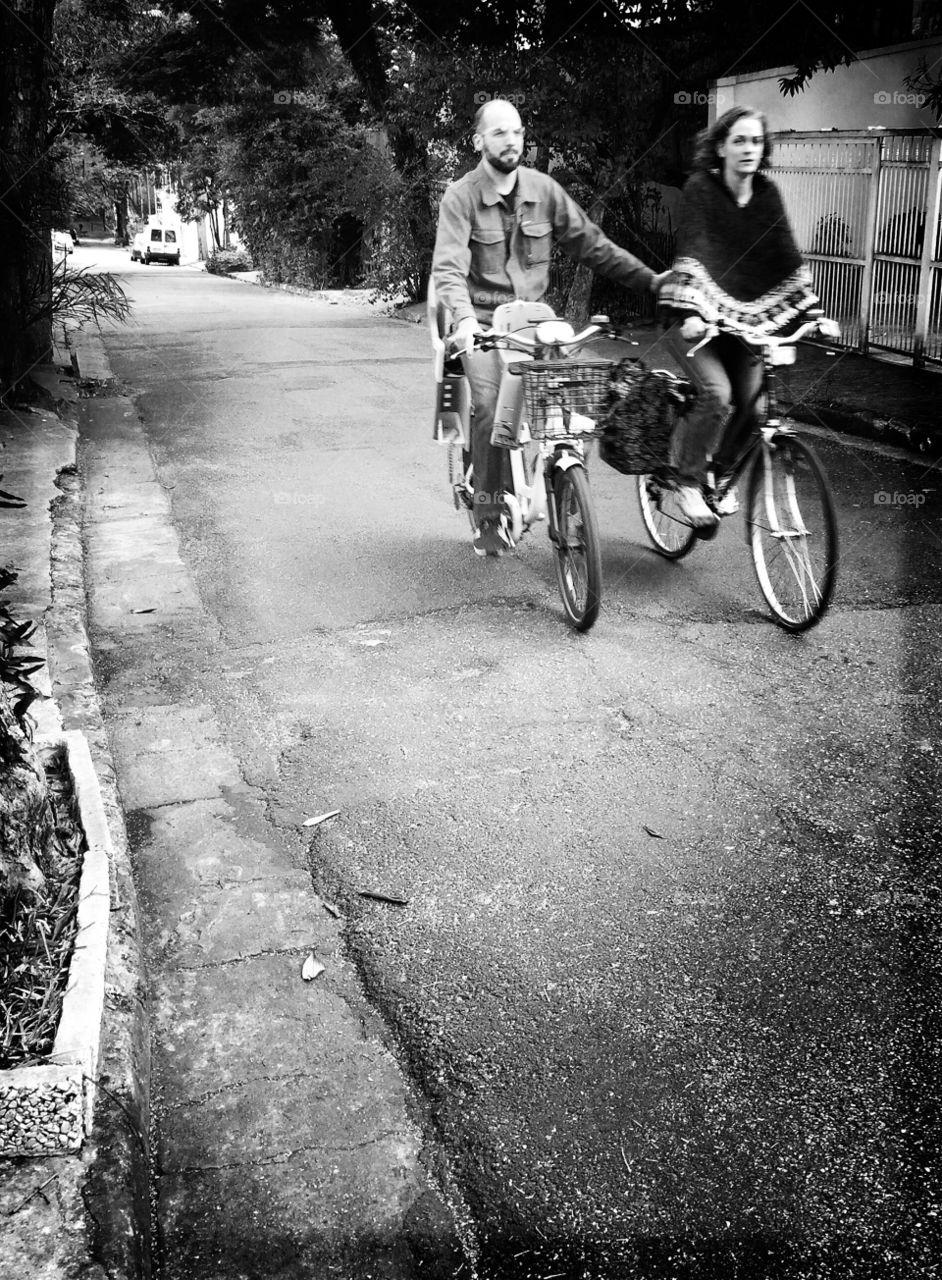 Couple of cyclists riding together on the street 