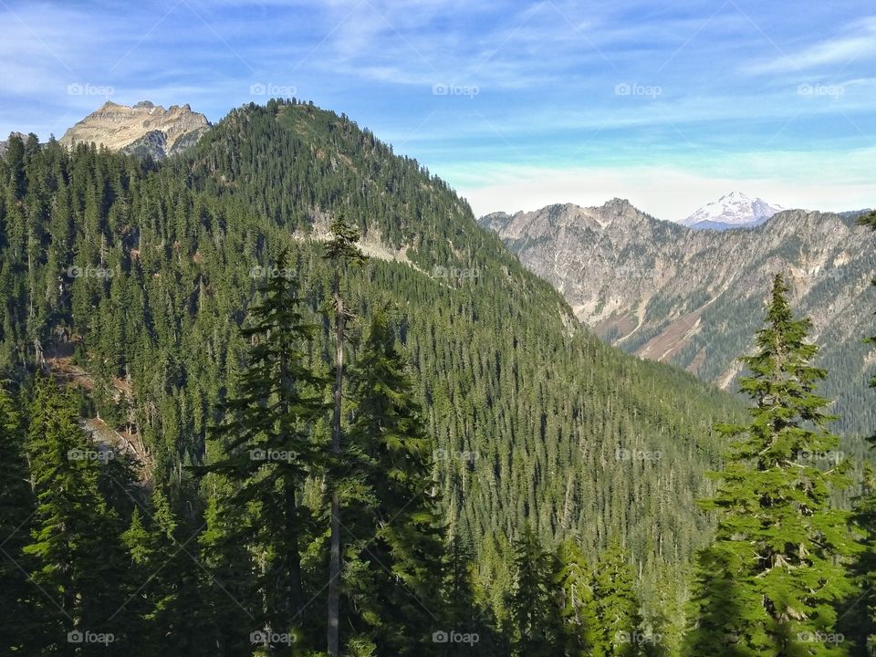 Scenic View of Mountain Peaks. A scenic view of Glacier Peak and mountain tops from Blanca Lake hiking trail in the Pacific Northwest