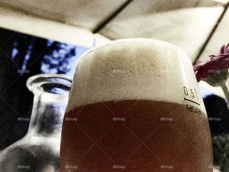 Low angle view of a glass of beer 