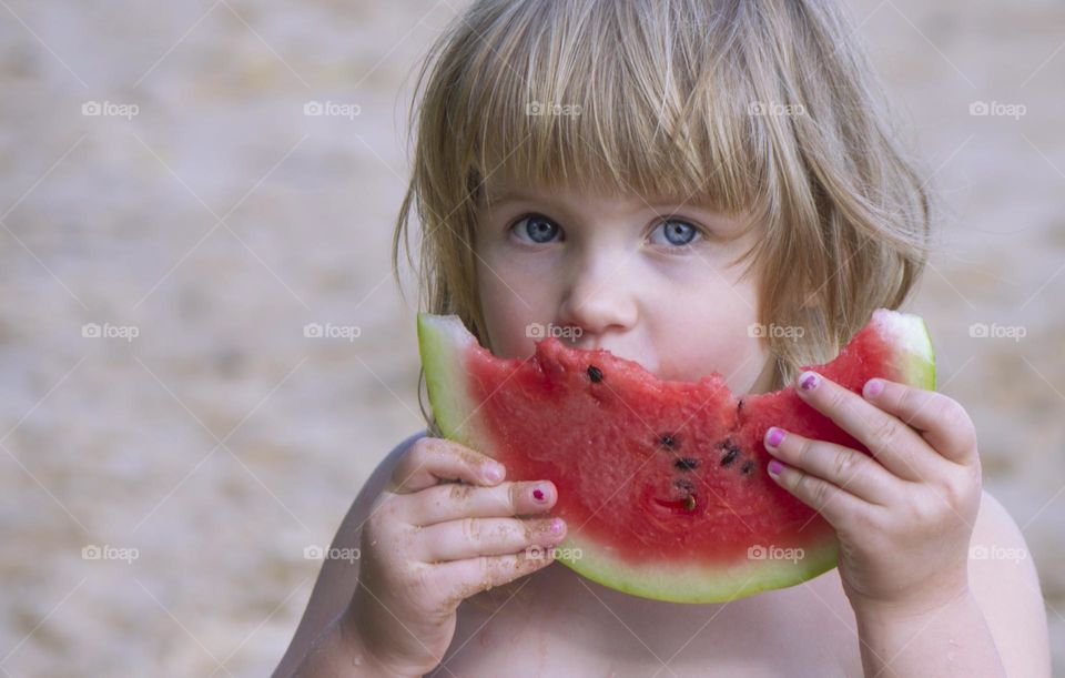 child eating watermelon