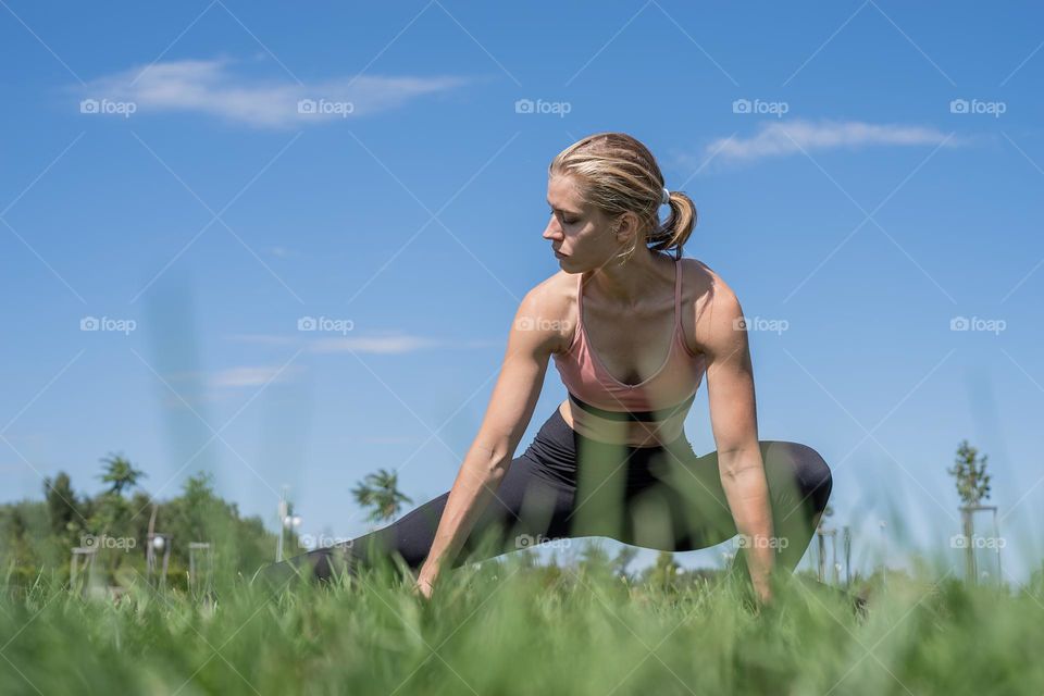 woman stretching in grass