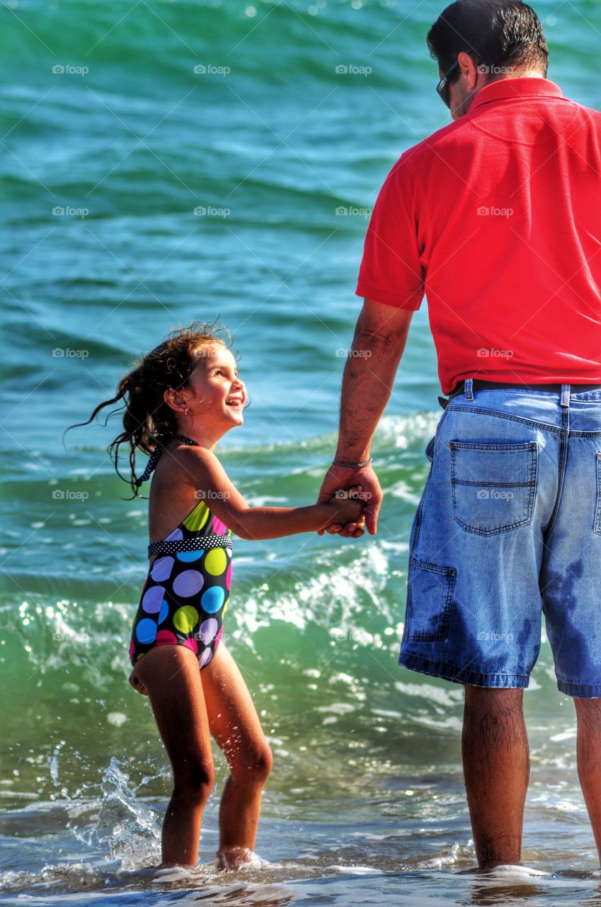 Father and girl at beach