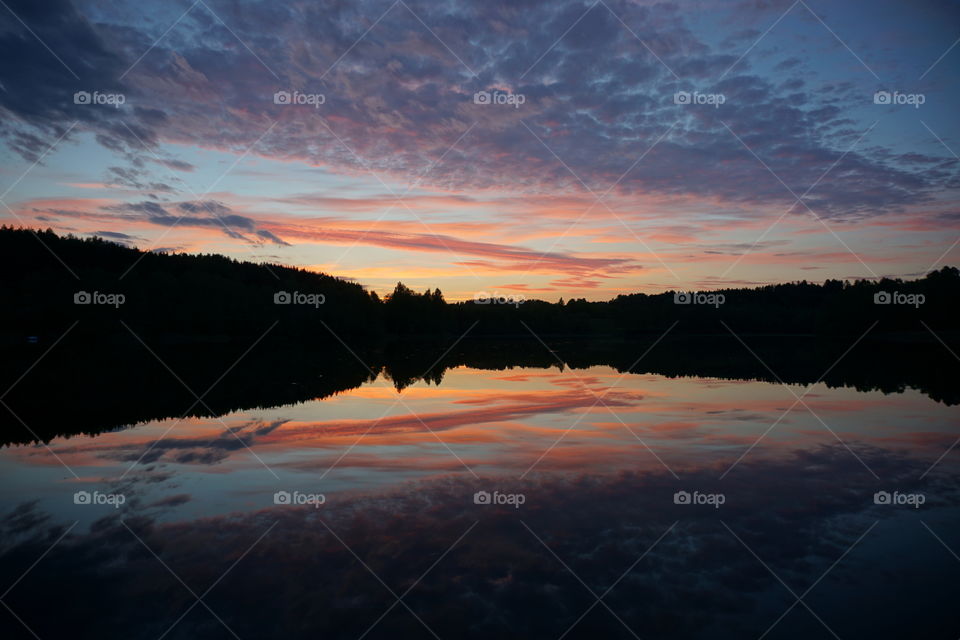 Incredible symmetry sunset on a lake in Lithuania