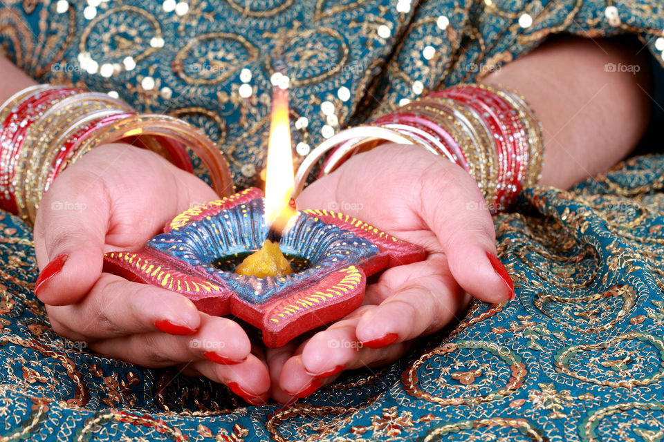 Indian festival Diwali diya in female hands