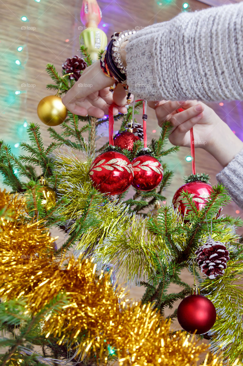 girl is decorating the Christmas tree