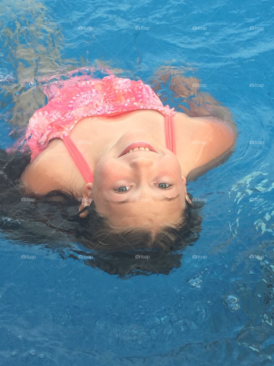 Portrait of a girl swimming in pool