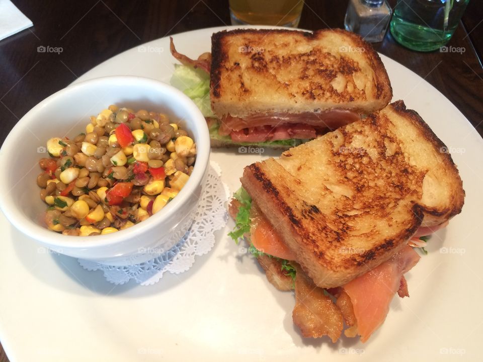 Smoked salmon BLT sandwich with a side of corn and lentil succotash