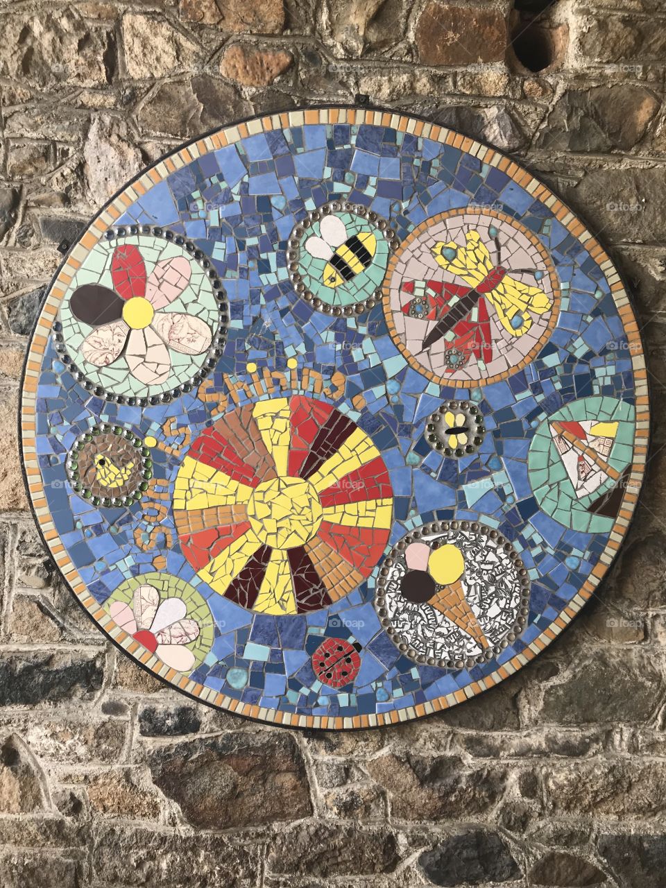 This mosaic appears to focus on creating art via shapes,  The outcome leaves the viewer an opportunity to imagine what the artists thoughts were. what do you think?