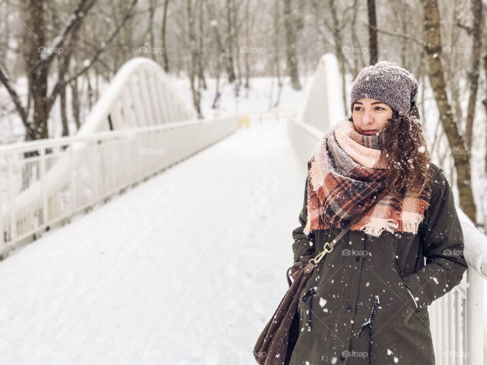 Portrait of young woman looking away during winter