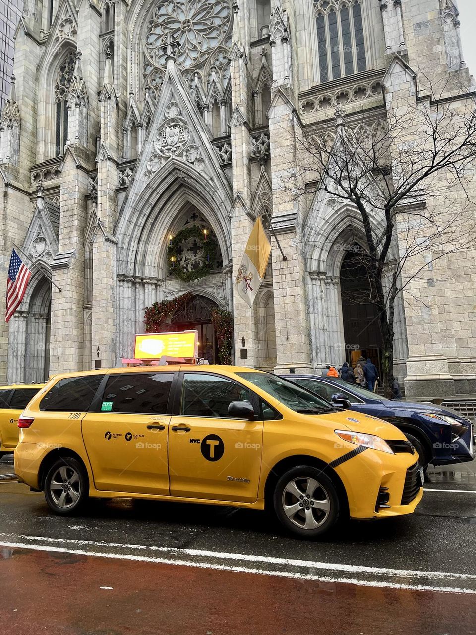 Yellow New York taxi in front of St. Patrick's Cathedral