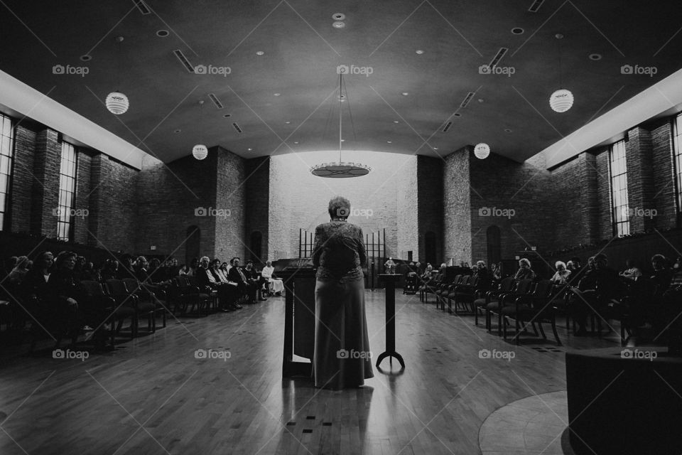 An elder speaking at the altar during a service