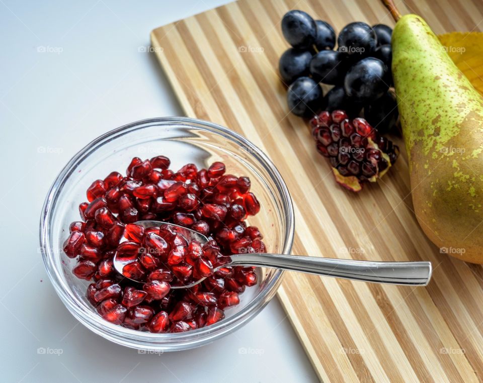 pomegranate seeds on a plate fresh healthy vegetarian food eating home and fruits on a wooden board