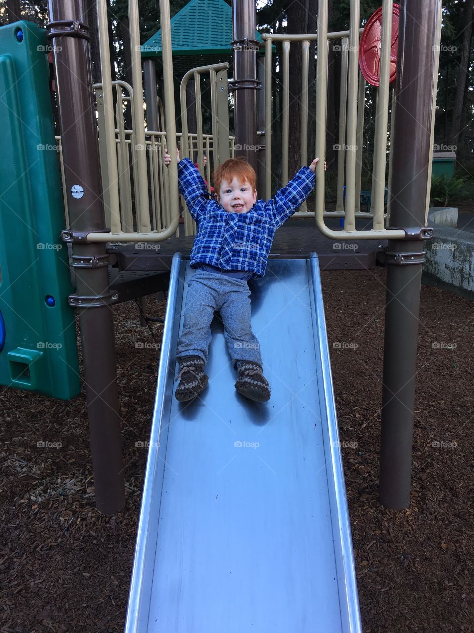 Toddler on the slide at the playground 