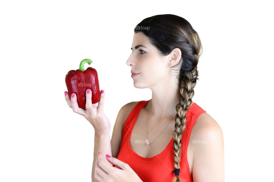 Girl looking at a big bell pepper