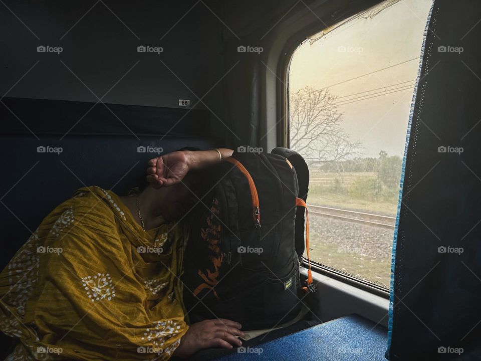 Women sleeping next to a window in a train