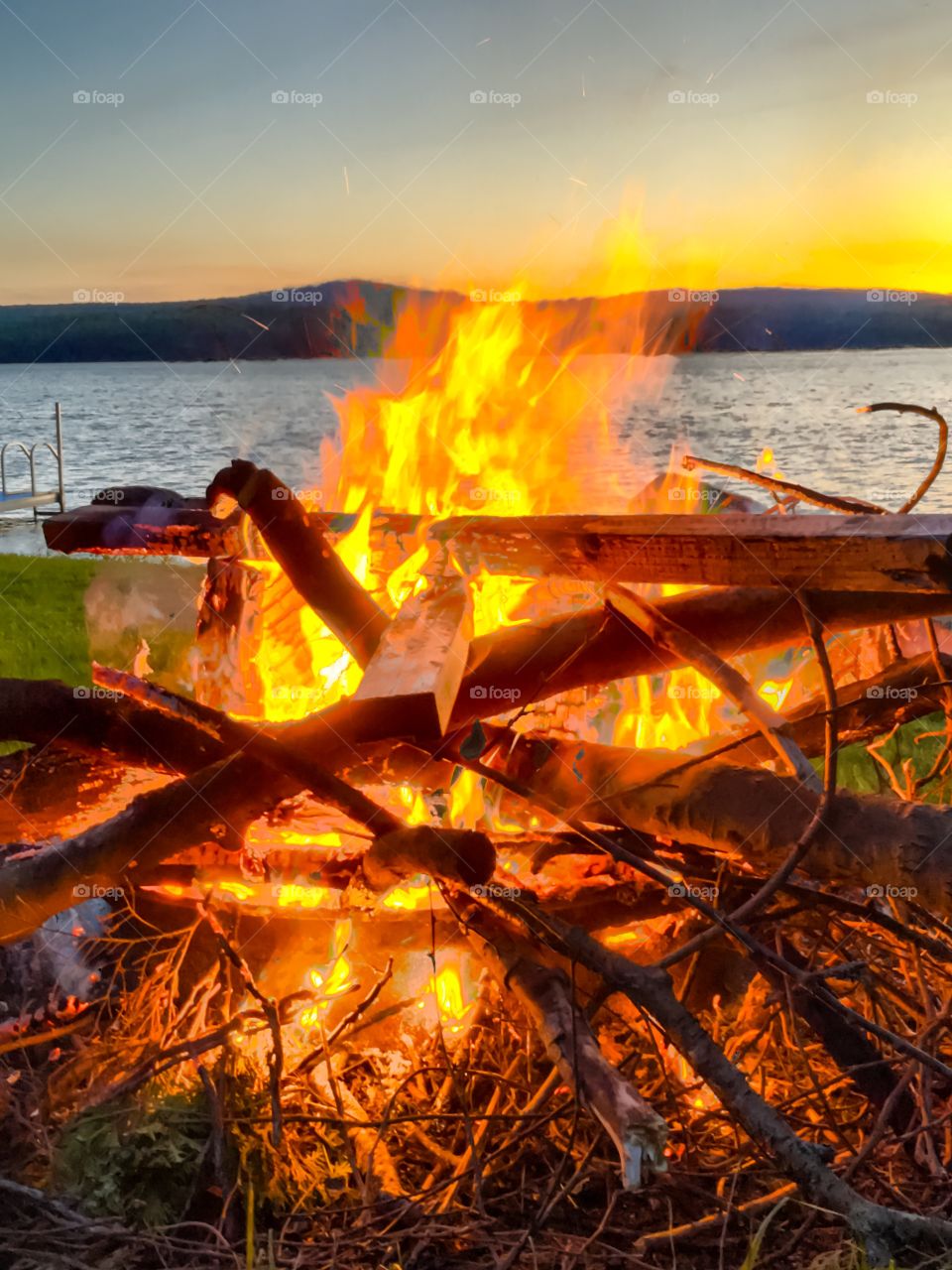 Campfire at sunset by the lake