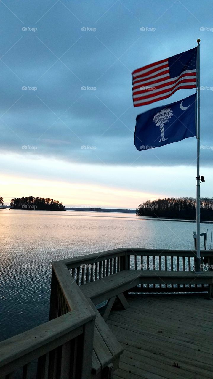 morning on the lake.  islands in the backgrpund, american and SC flag in the foreground.