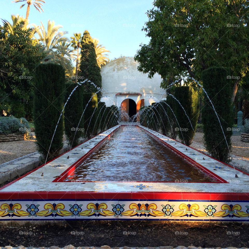 A fountain in a tropical park. A fountain in El Palmeral, a park in Elche, Spain