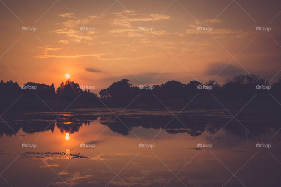 Scenic view of lake at sunset