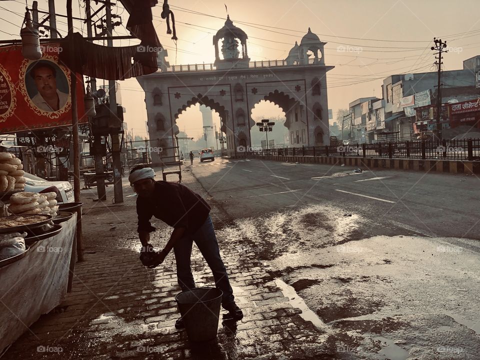 Street Food Vendor cleaning up before he starts work (India)
