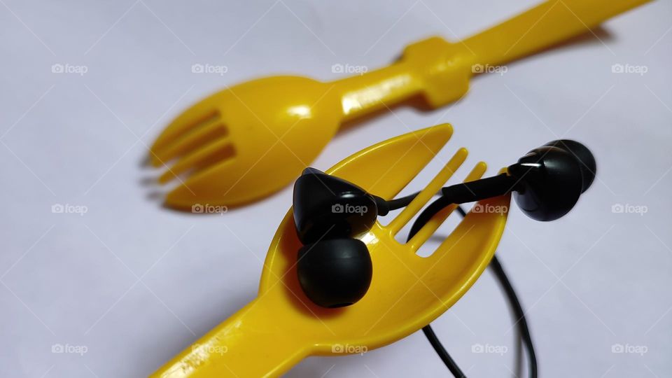 Yellow forks Trying to grab some music with earphones