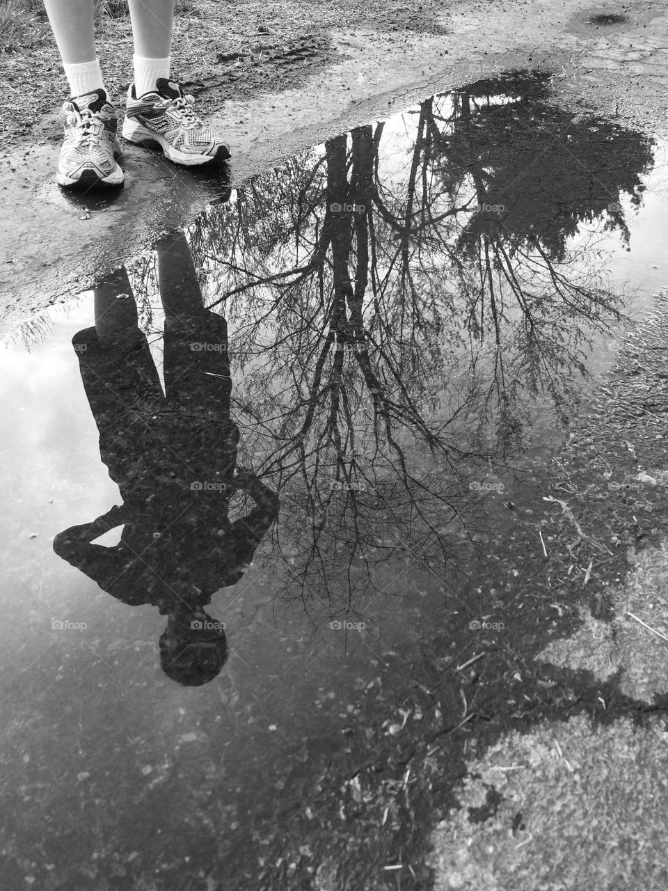 Boys reflection in a water puddle, black and white