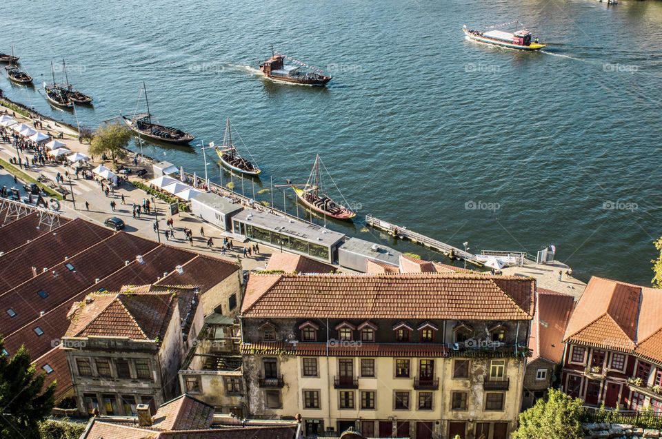 Looking downwards to buildings and boats along the Rio Douro in Porto