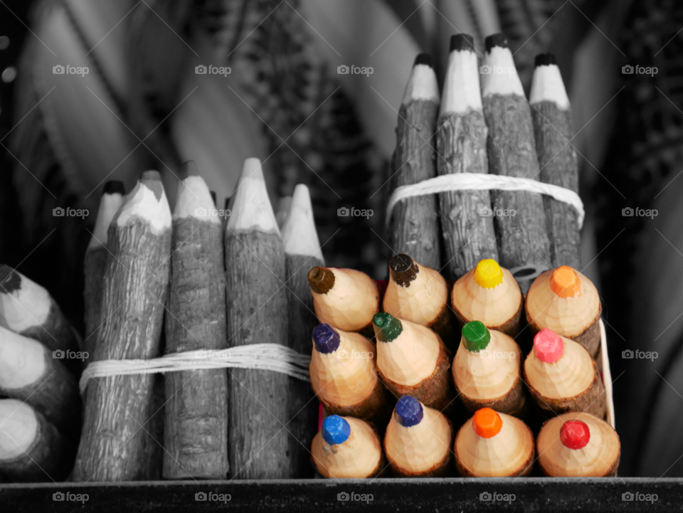 colorful pencils in the middle of black and white