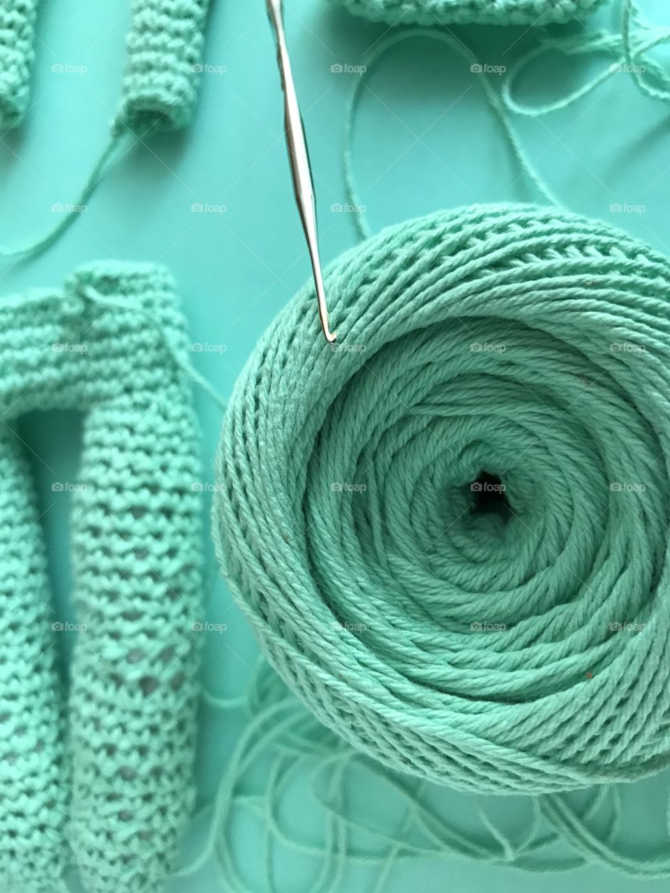 Knitting elements on green background 